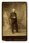 Standing portrait of Dr. Adalbert Johann (or John) Volck, featuring a nature-themed backdrop. Volck was a Bavarian dentist, artist, cartoonist, sculptor, and silversmith who first came to Baltimore, Maryland, to attend dental school. Volck remained in the Baltimore area after graduating in 1852, until his death in 1912.