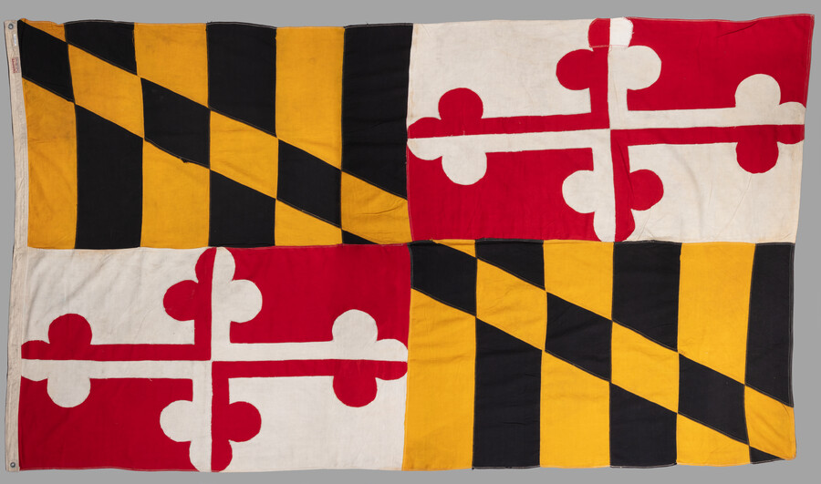 Linen Maryland state flag with metal grommets, c. 1904-1930. It was owned by Marylander Evelyn Fine Brotman (Mrs. Isidore Brotman) (1914-1986). Officially adopted by the state of Maryland in 1904, it combines the black and gold banner of George Calvert, 1st Baron of Baltimore (1580-1632) and Maryland Secretary of State (1618-1625), and the red and…