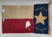 Handmade state flag of North Carolina, which was put into effect in 1861, used throughout the Civil War. The first date is known as the unofficial date of the "Mecklenburg Declaration of Independence," which was when a group of North Carolinians, hearing of the shots fired at Lexington, declared independence from Great Britain. The second…