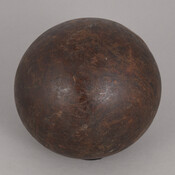 Small brown bowling ball used to play duckpin bowling. Made in Maryland shortly after the game was invented in Baltimore.