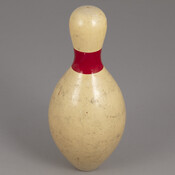 Duckpin bowling pin that was part of a set with matching ball. Made by a multi-generational family-owned company in Baltimore, Maryland. Pin is shorter and wider than a normal bowling pin.
