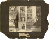 Photograph of pharmacist Dr. Howard E. Young in Young's Pharmacy at 1100 Druid Hill Avenue in Baltimore, Maryland.