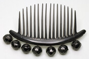 Curved black hair comb set at the top with seven large faceted jet beads.