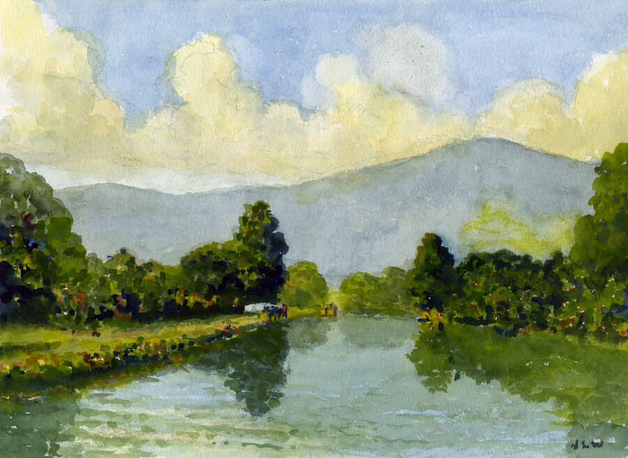 Landscape of the C&O Canal as viewed from the water. Blue mountains are seen in the background under a cloudy blue sky. Green grass and trees flank the water on either side. A small group of people stand on the bank in the distance,