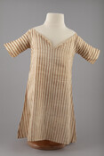Child's purple and white vertically-striped linen dress, now faded to brown. Garment has wide neckline with small placket center front where a drawstring is tied. T-shaped with gored skirt.