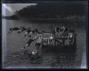 Women diving off a pier at YWCA Camp Pawatinka, Anne Arundel County, Maryland. Photographed by A. Aubrey Bodine, 1929.