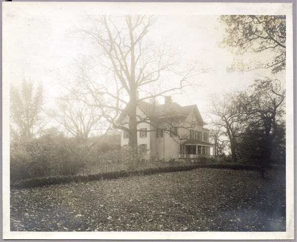 Side exterior view of Evergreen home and yard — undated