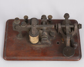 In 1843, Congress funded a 38-mile telegraph line along the B&O Railroad’s Washington Branch. On May 24, 1844, Samuel Morse (1791–1872) used a telegraph key like this one to send the first long-distance telegraph message “What Hath God Wrought?” from the basement of the U.S. Capitol building to the B&O’s Mount Clare Shops in West…