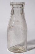 This clear glass milk bottle comes from prominent dairy farm in Maryland's history. It is embossed with the label, "Western Maryland Dairy / Health Department Permit 1 / One Pint."