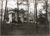 Side exterior view of the Evergreen House and grounds. The Evergreen estate was built by Baltimore, Maryland's Broadbent family in 1857, then was sold in 1878 to John Work Garrett, president of the Baltimore and Ohio Railroad. Garrett purchased the estate for his son, and it served as home to two generations of Garretts. In…