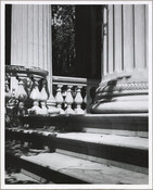 View of the front steps and columns of the Evergreen House. The Evergreen estate was built by Baltimore, Maryland's Broadbent family in 1857, then was sold in 1878 to John Work Garrett, president of the Baltimore and Ohio Railroad. Garrett purchased the estate for his son, and it served as home to two generations of…