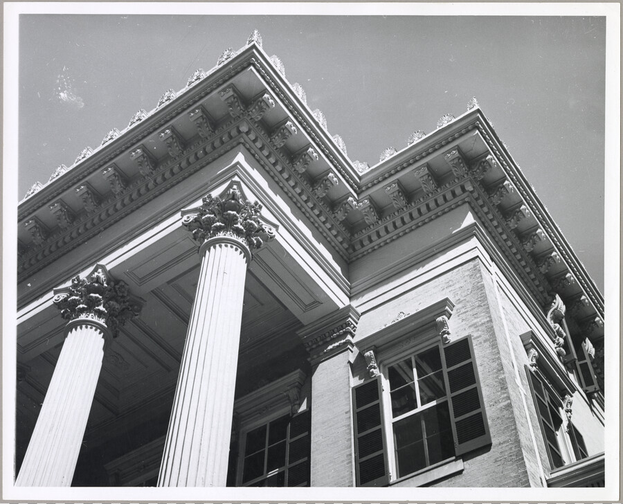 View of the columns and entablature adorning the front of the Evergreen House. The Evergreen estate was built by Baltimore, Maryland's Broadbent family in 1857, then was sold in 1878 to John Work Garrett, president of the Baltimore and Ohio Railroad. Garrett purchased the estate for his son, and it served as home to two…