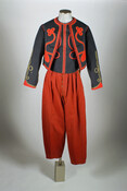 Zouave uniform of General Felix Agnus (1839-1925), an officer of the 165th N.Y. Volunteer Infantry, 2nd Battalion, Duryee's Zouaves. Uniform consists of a dark blue jacket, a vest, and a pair of red pants. The jacket and vest are elaborately trimmed with red braided cord and gilt ribbon.