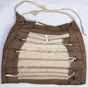 Brown linen bustle pad with drawstring waist.