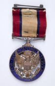 Distinguished Service Medal presented to Thomas Edward Hambleton by the United States Army for his service in World War I. The medal features the Great Seal of the United States; an emblem with an eagle behind a shield, clutching an olive branch in one talon and arrows in the other. The inscription on the medal…