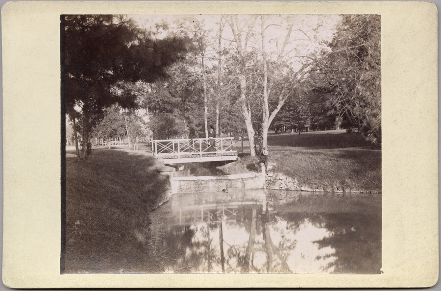 A pond and footbridge on the grounds of the original Guilford mansion, a home built by William McDonald after inheriting the land from his father General McDonald in 1850. Arunah S. Abell, founder of The Baltimore Sun, purchased the property in 1872 and it remained in the Abell family until it was sold to the…
