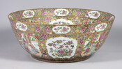 Large Chinese export ceramic punch bowl with rose flower and moth motif surrounding scenes of nature and Imperial court life.