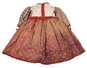 Child's red printed dress with scalloped collar and black piping details. Worn by a girl aged eight to ten years old. Skirt has two growth growth pleats and is pleated at waistband. Recycled fabrics used for lining. Closes in back with multiple hook and eye closures. Sleeves possibly could have been remade for the style…