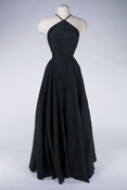 Black evening gown designed and worn by the fashion designer Claire McCardell (1905-1958). The two-piece gown consists of a halter top that is secured with a tie and a full length circle skirt.