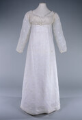 White muslin dress day dress with empire waist and spencer with full-length sleeves. Embellished with white satin stitch embroidery and tambour work throughout. Drawstrings at the bust, back fastening, and on sleeves.