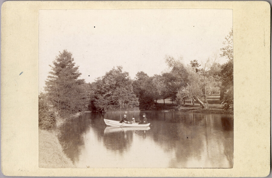 Two women and a child in a small boat on a lake near the original Guilford mansion, a home built by William McDonald after inheriting the land from his father General McDonald in 1850. Arunah S. Abell, founder of The Sun, purchased the property in 1872 and it remained in the Abell family until it…