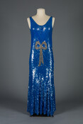 Woman's blue sequined shift "chemise" dress decorated with a bow made from faux crystals in front. Made in France for sale in Hutzler Brothers department store in Baltimore, Maryland and worn by Carolyn Fuld Hutzler, wife of Joel Hutzler.