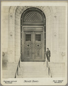 The bronze doors of the Maryland Institute in Baltimore, Maryland, and an unidentified man. Beneath the image is the text "Maryland Institute Baltimore" at left, and "Fell & Corbett, Architects" at right.Verso transcription: The L. Schreiber & Sons Co., Cincinatti, Ohio.