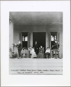 Portrait of the Perine family on the steps of the Homeland estate, including Elias Glenn Perine, his wife Eliza Ridgely Beall Washington Perine, and their children Washington, Mildred, Mary, Annie, George, and David. Elias stands behind his seated family while Washington and David bookend the scene beside their penny-farthings. The estate was situated in what…