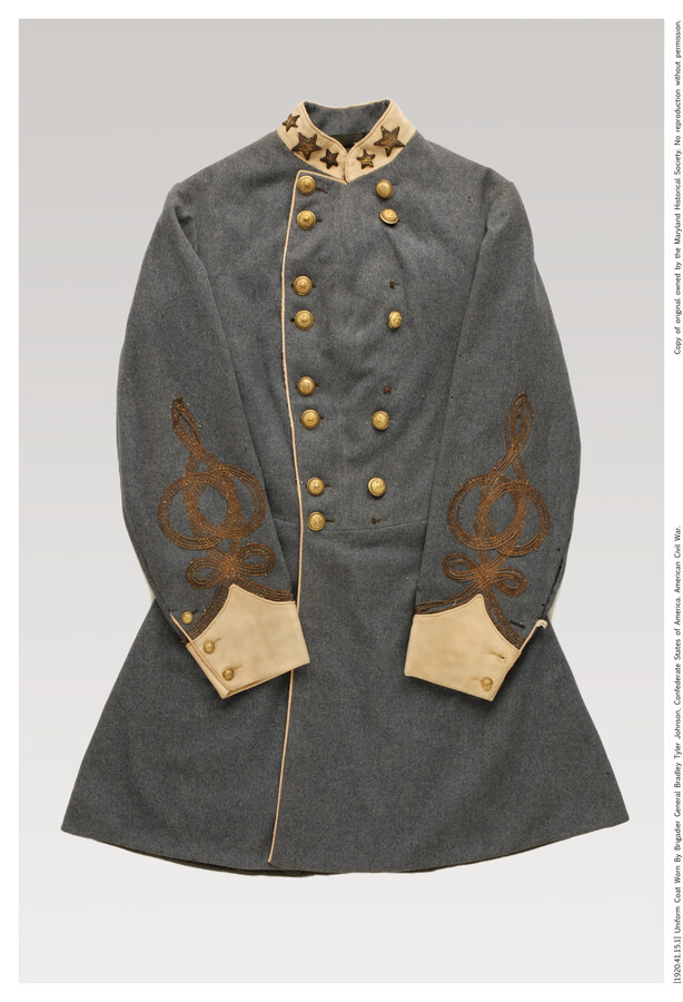 Confederate States Army uniform coat worn by Brigadier General Bradley Tyler Johnson (1829-1903). Long grey coat with two rows of eight brass buttons, some missing. Collar insignia of gold stars indicates rank of full colonel (1862-1864), with one star missing. Standard for confederate officers coats was the gold embroidered trim on the sleeves. Johnson was…
