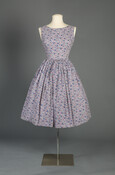 Adina Mae Via Robinson’s (1937–1966) love for sewing is reflected in this dress. Robinson added her own stylish touches with her choice of a floral and umbrella patterned fabric and two large, faux pearl buttons for the back closure. Not only representative of the larger trend of home-sewn clothing, Robinson’s dress speaks of her own…