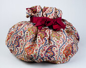 This drawstring bag, constructed of paisley wool challis, was made by Elizabeth Patterson Bonaparte (1785-1879) for her great-niece, Mrs. W. Hall Harris (nee Alice Patterson) of Baltimore. The fabric came from one of Elizabeth's dresses. The bag was likely used to hold sewing materials.