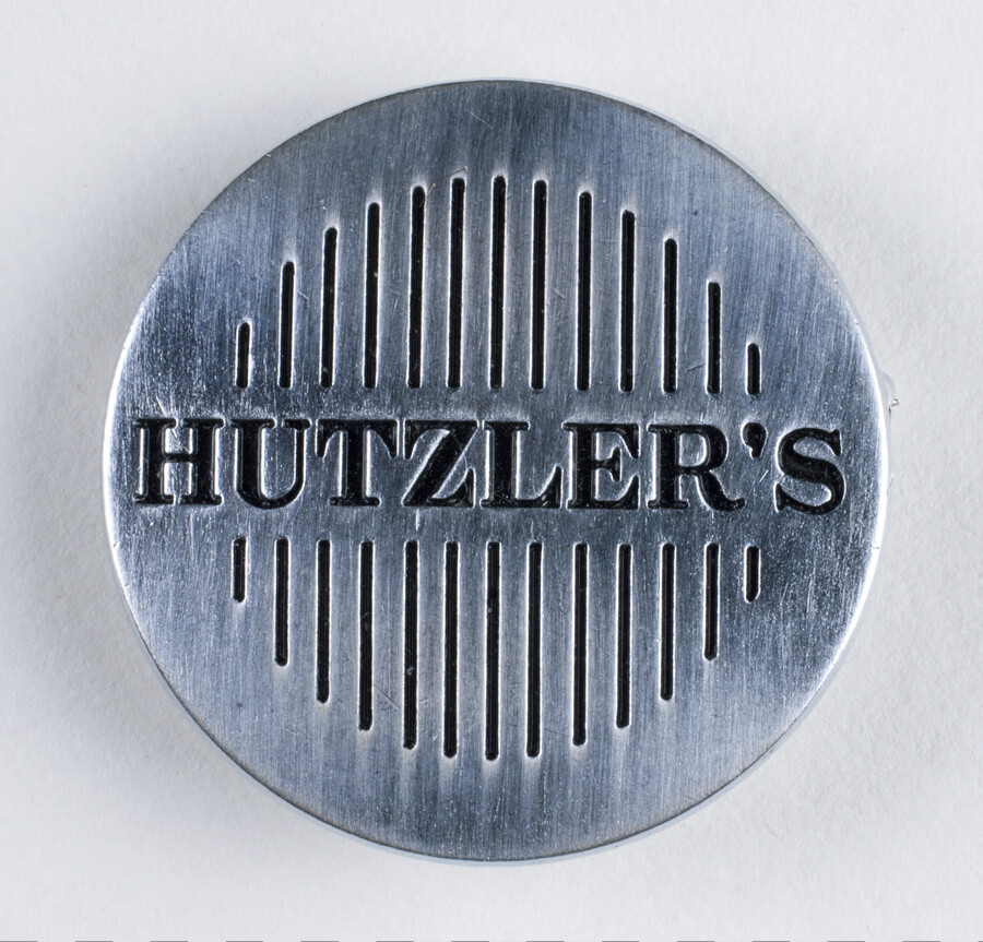 Employee pin from a Hutzler's department store. Worn by Thelma C. Weber Simms (1914-1986), who worked as a part-time saleslady during the 1950s. She lived in Dundalk, Maryland, and worked at the Howard Street location in downtown Baltimore.