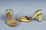 Size 7 sling-back heels with mustard-colored suede at tip and scalloped, pierced lemon-colored leather over arch. This pair of shoes was purchased at a Hutzler's department store in the 1970s.