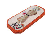 Eyeglass case embroidered by and belonging to American fashion designer Claire McCardell (1905-1958), who was born in Frederick, Maryland. A mannequin with a garment on it is made in needlepoint on the front of the case, while the other side of the case features needlepoint scissors and a pin cushion.