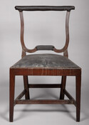 Mahogany side chair with leather covered drop in seat, an H-stretcher between the legs, and a missing center back splat. This chair furnished Henry Fite's Tavern, famously known as "Congress Hall," which was located on Market Street in Baltimore, Maryland. Henry Fite (1722-1789), who was born Heinrich Voigt, immigrated to Philadelphia, Pennsylvania, from Germany in…