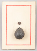 Bullet that wounded the hand of Jesse Levering, a merchant of Baltimore, at the Battle of Bladensburg in 1814. Bullet is mounted on a paper card.