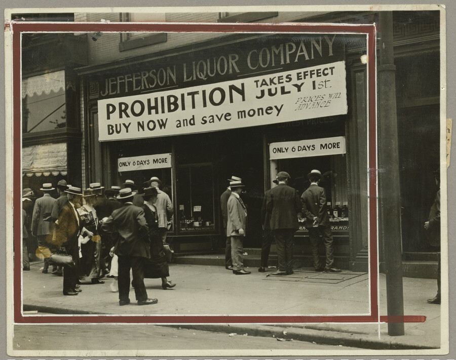 A group of people stand outside the Jefferson Liquor Company storefront located at 15 North Liberty Street in Baltimore, Maryland. Signage on the storefront reads “Prohibition takes effect July 1st / Buy now and save money.” Prior to ratification of the Eighteenth Amendment, the U.S. Congress passed the temporary Wartime Prohibition Act on November 18,…