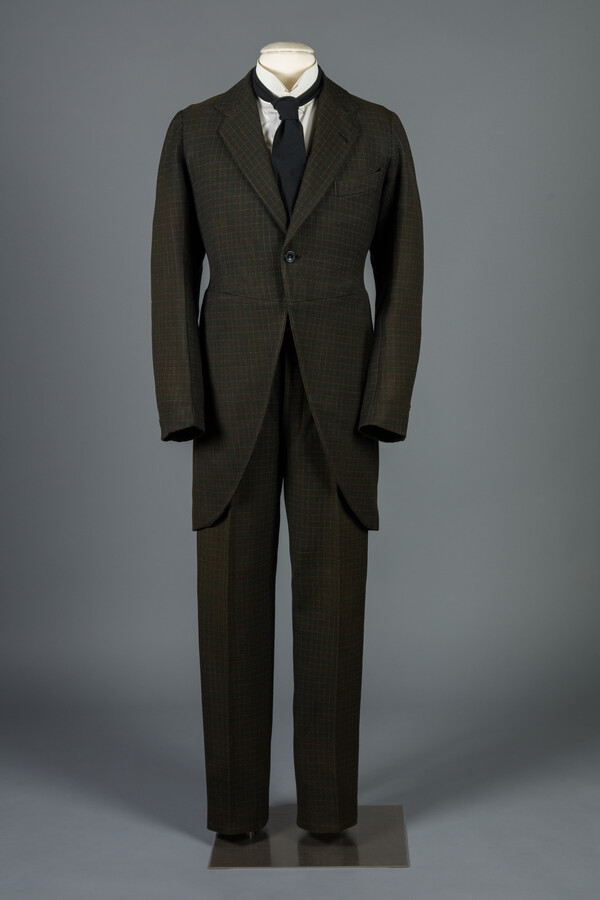 Dark green wool plaid suit that consists of jacket and pants.
