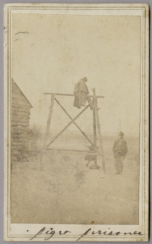 Unidentified soldier sitting astride punishment device at Point Lookout, Maryland — circa 1863-1865