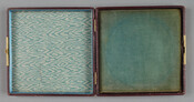 Red square metal case with gold border, lined inside with turquoise velvet on one side and turquoise watered silk on the other. An inscription reads, "The Confederate States of America: 22 Feb 1862, Deo Vindice." Belonged to Dr. Joseph Pembroke Thom (1828-99), who served as a colonel and surgeon in the Confederate Army.