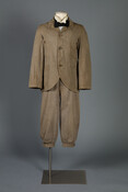 Tan wool-cotton twill bicycling suit that consists of a jacket and knickerbockers.