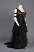 Black silk evening dress with sequins, beads, chiffon overlay, long net skirt panels to create a lampshade effect, and a train.