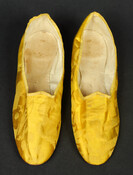 Pair of yellow silk brocade slippers with narrow oval toe and low stacked heel. Belonged to Rachel Gratz Etting (1764-1831).
