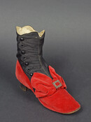 Ladies' black silk and red velvet boot with low heel. Boot closes with seven black buttons on one side. Red velvet covers the heel and toe box, forming a bow above the tow that is centered with a small metal buckle. This shoe belonged to Helen West Stewart Ridgely (1854-1929) (Mrs. John Ridgely) of Hampton…