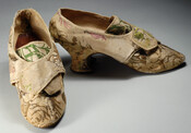 Ladies' ribbed silk dress slippers with brown, green, pink, and white floral embroidered designs and a french heel. Shoes have rounded toes with broad tongue crossed over by two flaps. Belonged to Mrs. John Moale (Ellin North). Ellin (1740-1825) married John Moale (1730-1798) on May 25, 1758 at St. Paul's in Baltimore.