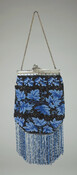 Beaded purse with blue leaf design over black background. Purse opens with a silver clasp with attached chain handle. Bottom edge of bag embellished with blue looped, beaded fringe.