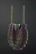 Loom-woven beaded bag characterized by emerald green and purple horizontal stripes. Decorative bead loops are attached to purple stripes. Two attached strap handles woven with same beads. Green silk lining with hidden black cord to provide stability and slightly cinch opening.