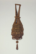 Brown beaded crocheted bag of purse silk and seed beads. Beads stitched in a circular shape with four rows of looped self-fringe. Top is shaped to form two handles joined with a beaded ring. Another ring slides down to close bag. Bottom trimmed with beaded ball and decorative beaded looped tassel. Lined with brown silk…