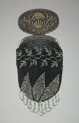 Tam O'Shanter style black knitted pouch decorated with steel cut beads in a leaf pattern. Interlaced beaded loop fringe at bottom edge. Silver metal spring-clasped oval-shaped top embossed with heraldic design.