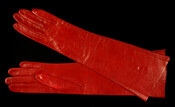 Pair of red elbow-length kid leather gloves, size 6-1/2. Likely purchased at O'Neils or Hutzlers in Baltimore, Maryland.